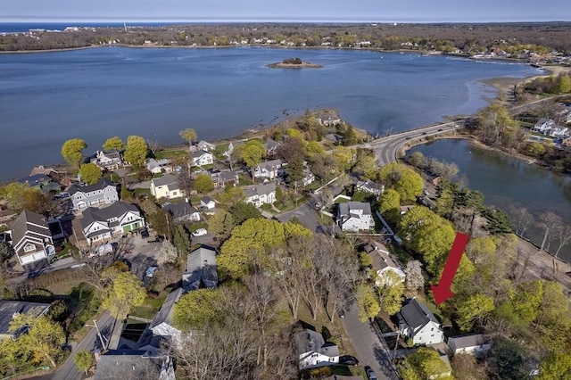 drone / aerial view with a residential view and a water view