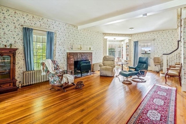 48 Neal Gate St, Scituate, MA 02066 - living area featuring a fireplace, wood-type flooring, wallpapered walls, and radiator