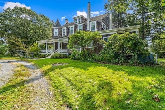 48 Neal Gate St, Scituate, MA 02066 - back of property with dirt driveway, covered porch, and fence