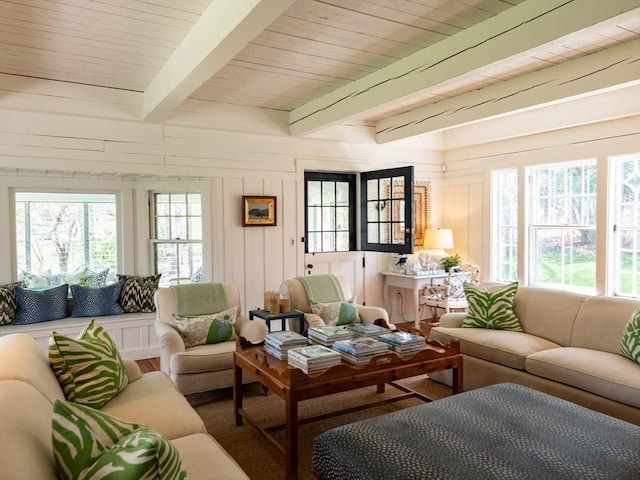 sunroom with plenty of natural light, french doors, and beam ceiling