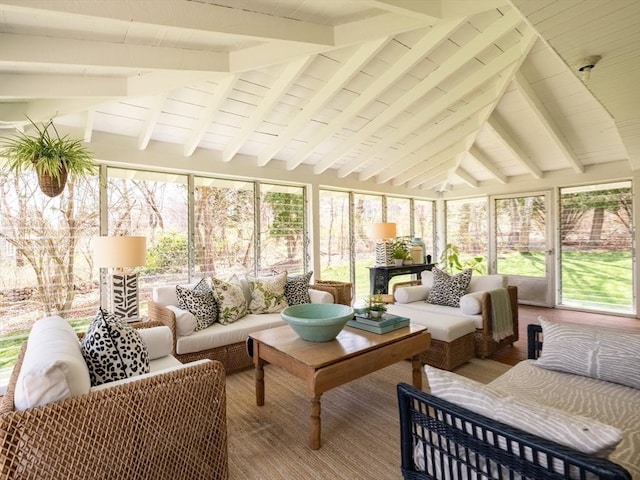 sunroom / solarium with lofted ceiling with beams, a healthy amount of sunlight, and outdoor lounge area
