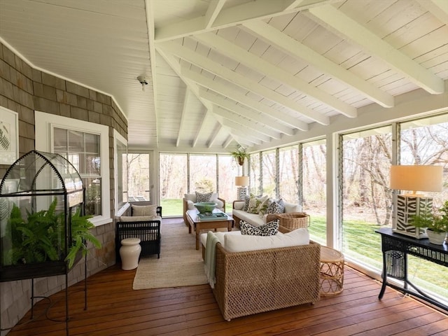 sunroom featuring beamed ceiling and outdoor lounge area