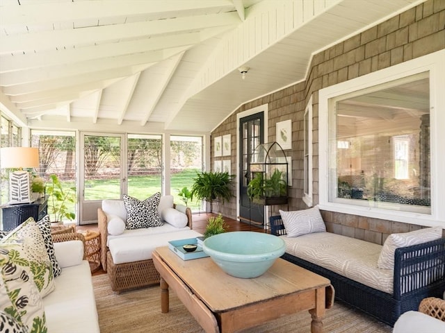 sunroom featuring plenty of natural light and beamed ceiling
