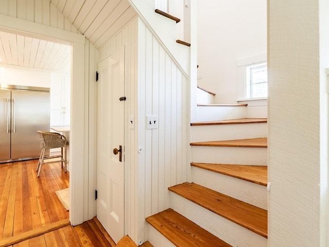 stairway with hardwood / wood-style flooring