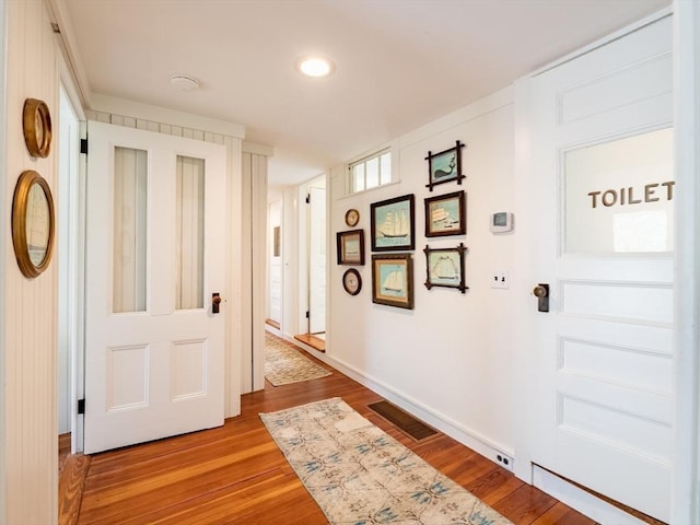 corridor featuring recessed lighting, baseboards, light wood finished floors, and visible vents