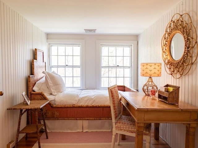 bedroom with visible vents and wallpapered walls