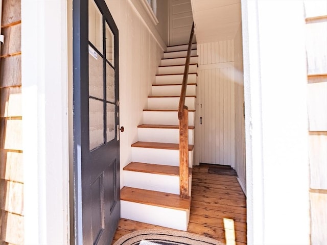 staircase featuring wood-type flooring