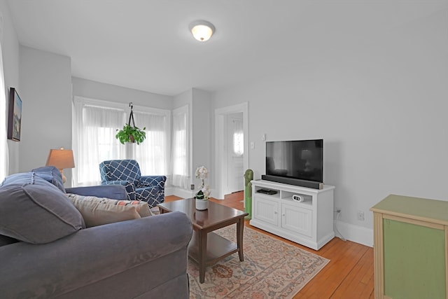 246 Railroad Ave, Norwood, MA 02062 - living room featuring baseboards and light wood-style flooring