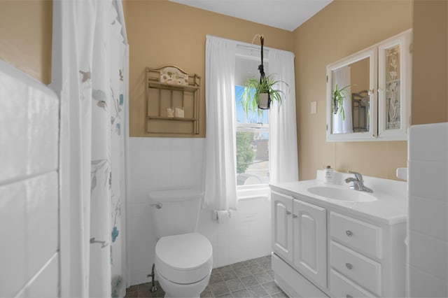 246 Railroad Ave, Norwood, MA 02062 - full bathroom featuring vanity, tile walls, and wainscoting