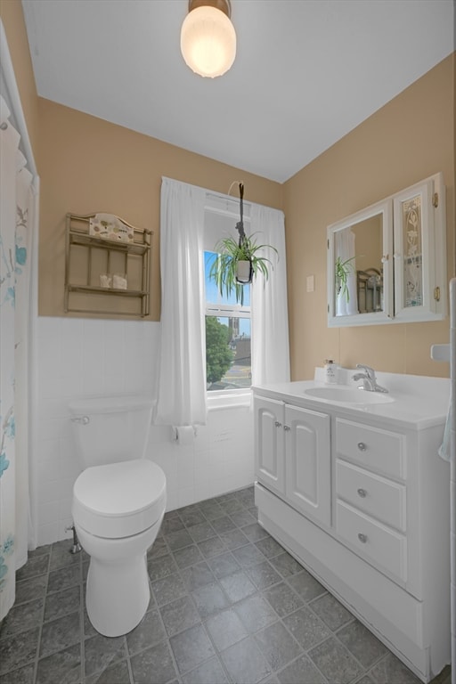 246 Railroad Ave, Norwood, MA 02062 - bathroom with vanity, a wainscoted wall, and tile walls