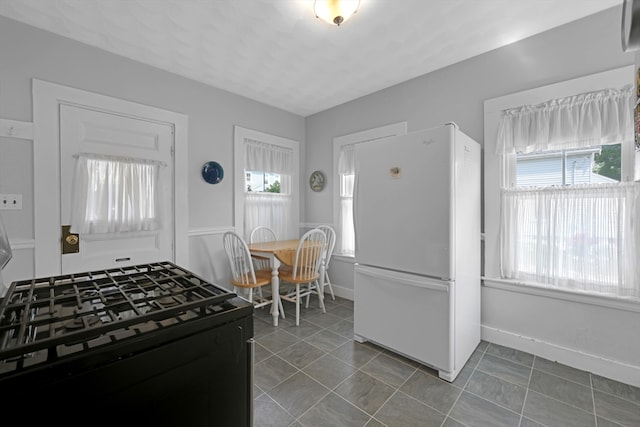 246 Railroad Ave, Norwood, MA 02062 - kitchen featuring freestanding refrigerator and black range with gas stovetop