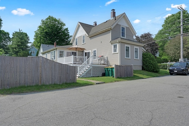 246 Railroad Ave, Norwood, MA 02062 - view of side of home with stairs, a chimney, and a wooden deck