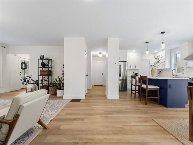 interior space with baseboards and light wood finished floors