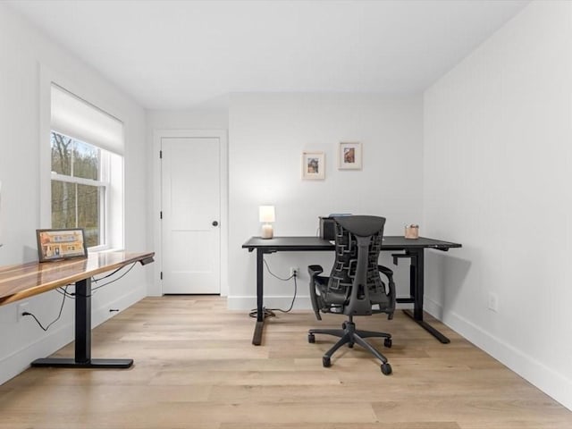 office space featuring baseboards and wood finished floors