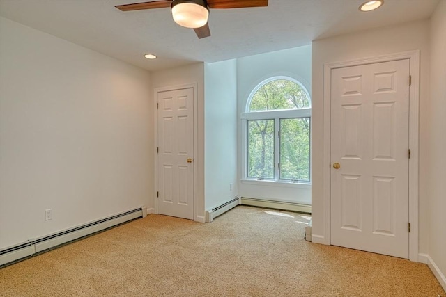 empty room featuring a baseboard radiator, light colored carpet, a ceiling fan, recessed lighting, and baseboards