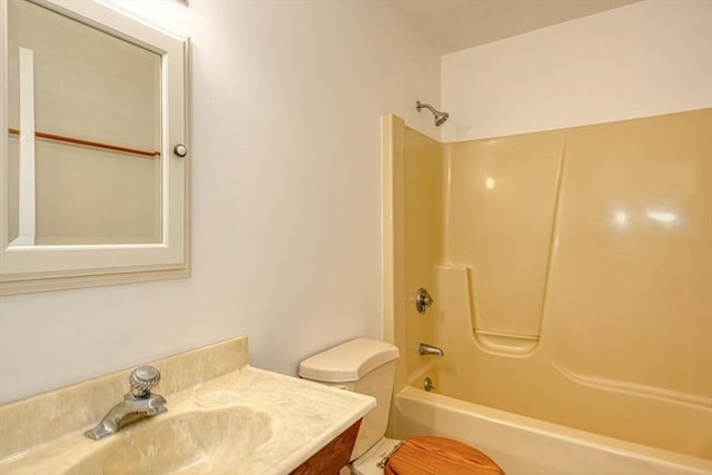 bathroom with shower / washtub combination, vanity, and toilet
