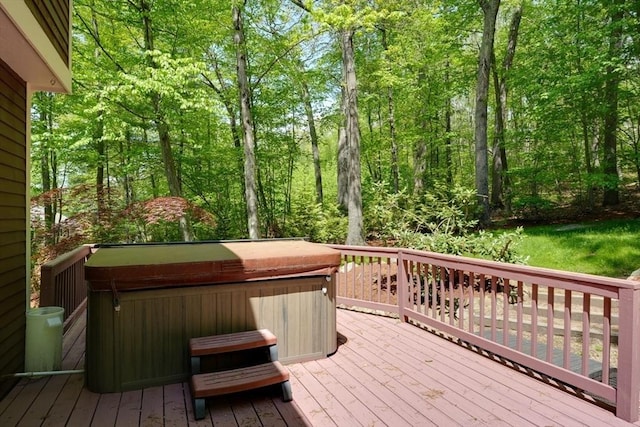 wooden terrace featuring a hot tub