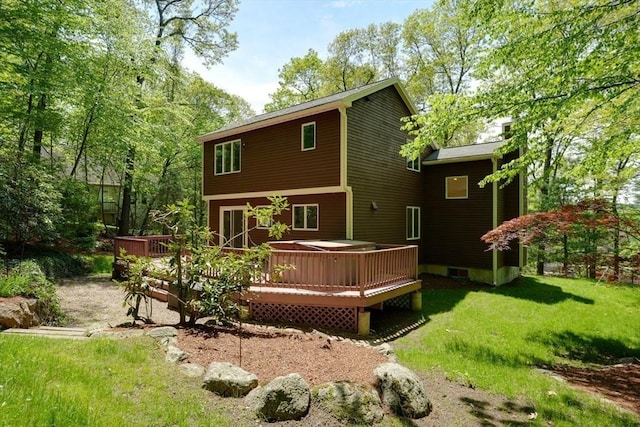 rear view of property with a wooden deck and a yard