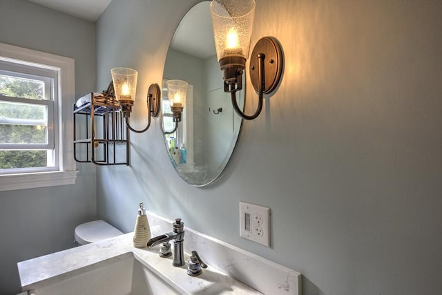 half bathroom featuring toilet and a sink