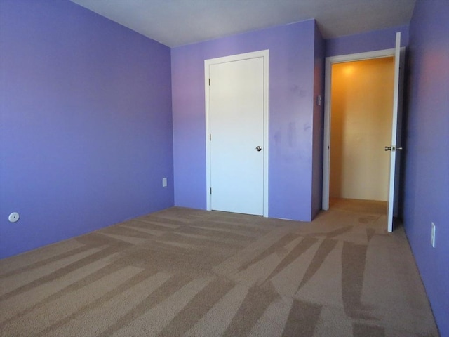 unfurnished bedroom featuring light colored carpet