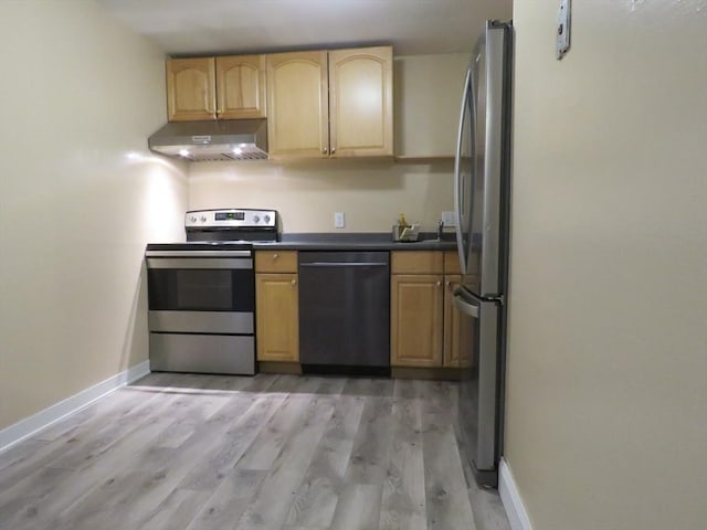 kitchen with stainless steel appliances, light brown cabinets, and light wood-type flooring