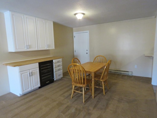 carpeted dining space with wine cooler and a baseboard radiator