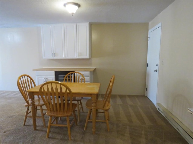 dining space featuring a baseboard radiator and dark carpet