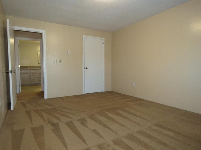 unfurnished bedroom featuring light colored carpet