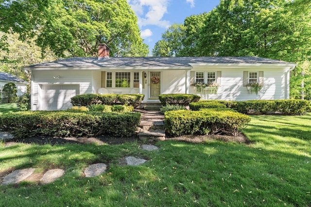 ranch-style home featuring a chimney, a front yard, and an attached garage