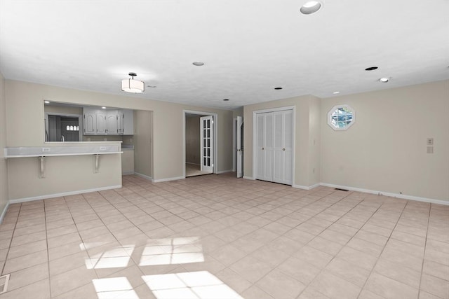 unfurnished living room featuring baseboards and recessed lighting
