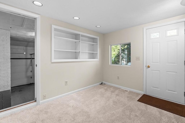 empty room with baseboards, carpet, recessed lighting, and attic access