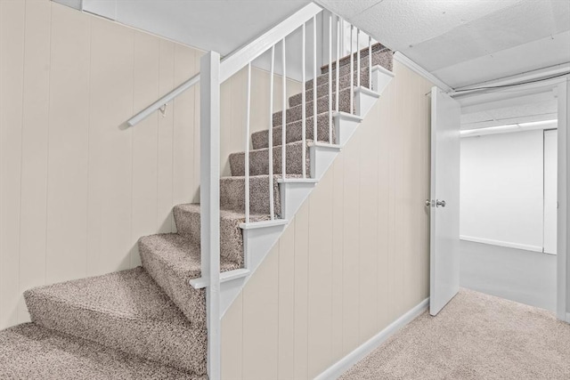 staircase with carpet floors and baseboards
