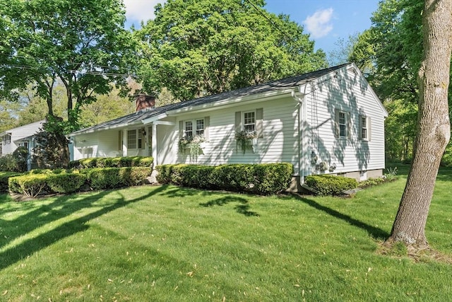 view of front of house with a front lawn and a chimney
