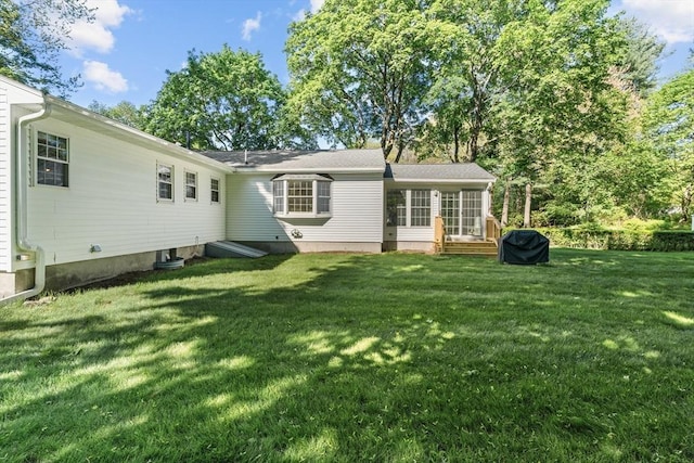 rear view of property featuring a yard