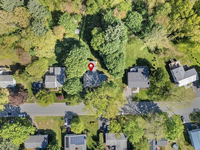 aerial view of property and surrounding area featuring nearby suburban area