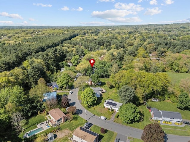 view of property location featuring a heavily wooded area