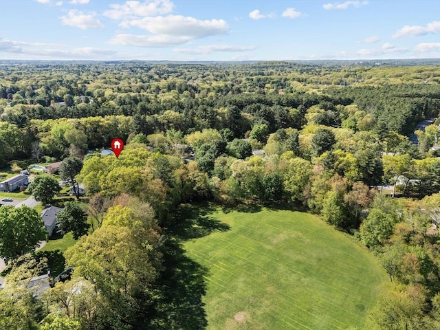 aerial view of property's location featuring a forest