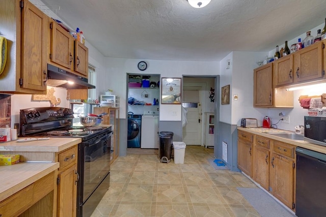25-29 Chapel St, Norwood, MA 02062 - kitchen with black appliances, under cabinet range hood, light countertops, washing machine and clothes dryer, and brown cabinetry