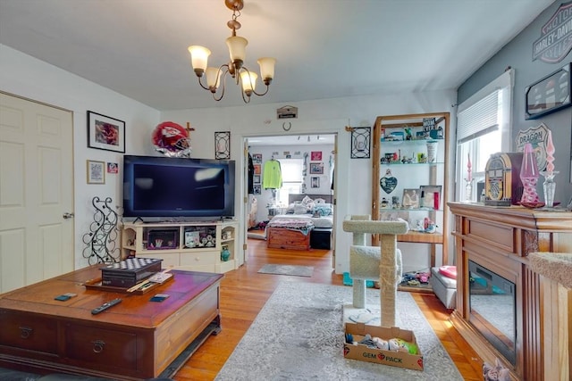 25-29 Chapel St, Norwood, MA 02062 - living room with a chandelier, light wood-type flooring, and a glass covered fireplace