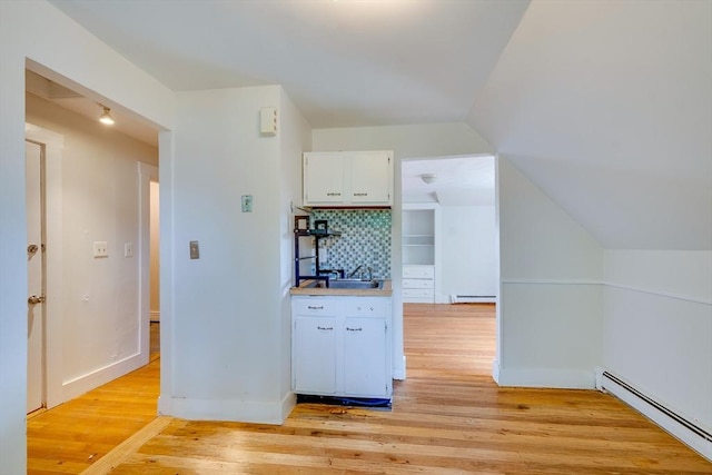 25-29 Chapel St, Norwood, MA 02062 - bar area featuring a baseboard radiator, a baseboard heating unit, light wood-style flooring, and backsplash