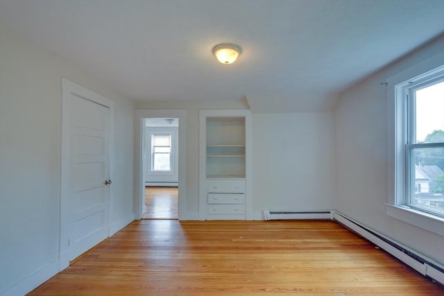 25-29 Chapel St, Norwood, MA 02062 - bonus room with plenty of natural light, light wood-type flooring, a baseboard heating unit, and baseboard heating