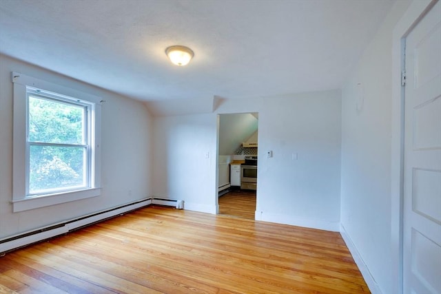25-29 Chapel St, Norwood, MA 02062 - unfurnished room with light wood-style floors, a baseboard heating unit, and vaulted ceiling