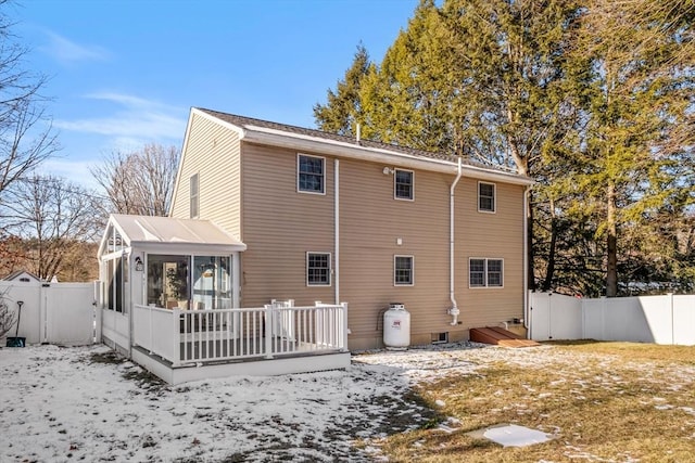 back of property featuring a sunroom and a deck