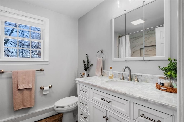 bathroom with hardwood / wood-style flooring, vanity, toilet, and curtained shower