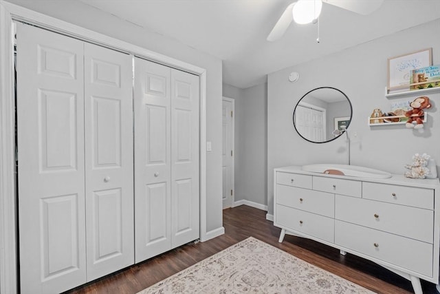 bedroom featuring dark wood-type flooring, a closet, and ceiling fan