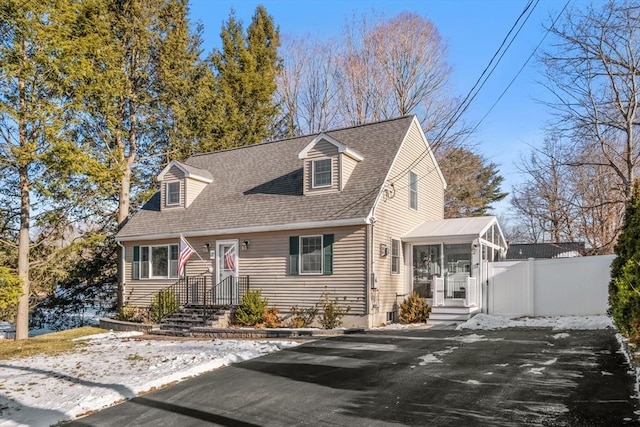 new england style home with a sunroom