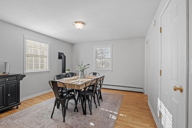 dining area featuring baseboard heating and light hardwood / wood-style floors