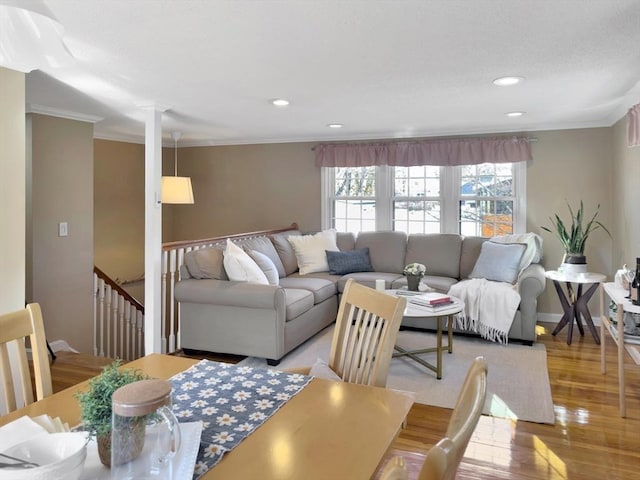 living room with ornamental molding, recessed lighting, and light wood-style floors