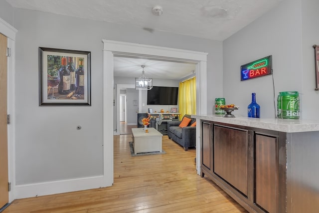 interior space with light hardwood / wood-style flooring and a notable chandelier