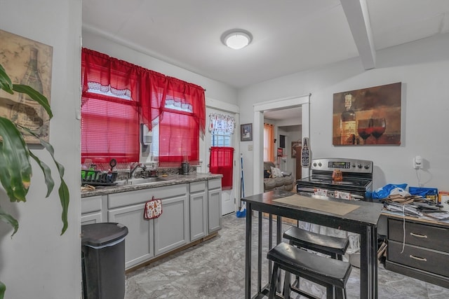 kitchen featuring beam ceiling, electric stove, sink, and gray cabinets